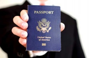 a man in a suit holding out his passport